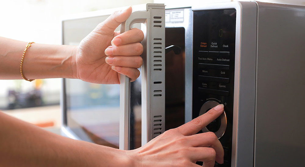 Person Shutting Microwave Door