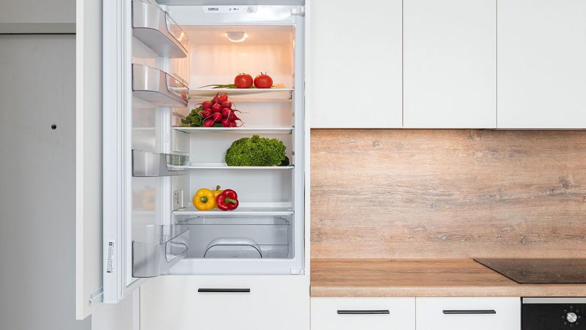 Open top door of a refrigerator with vegetables