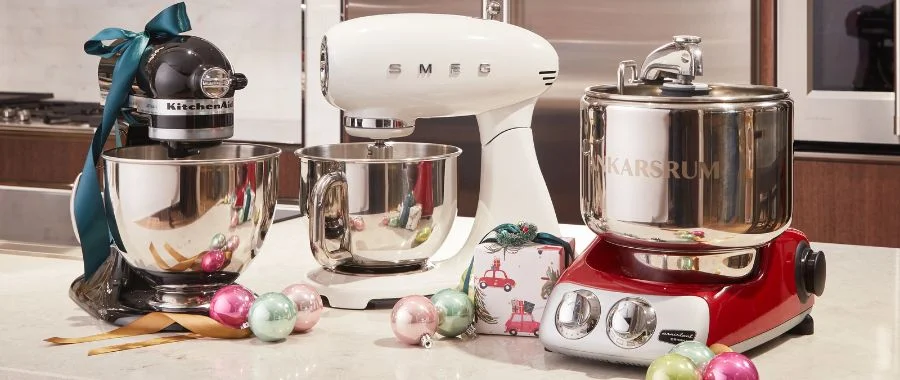 three different stand mixers in a holiday kitchen