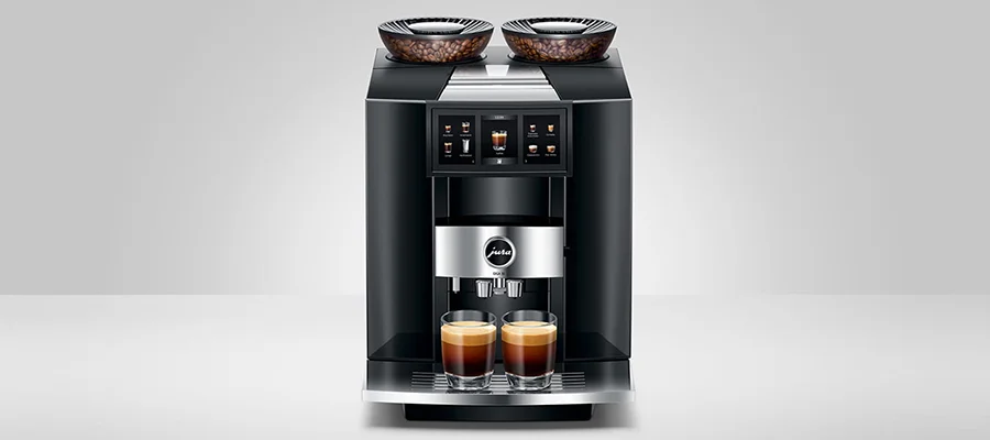 A black Jura GIGA 10 coffee machine with two shots of espresso sitting on the tray