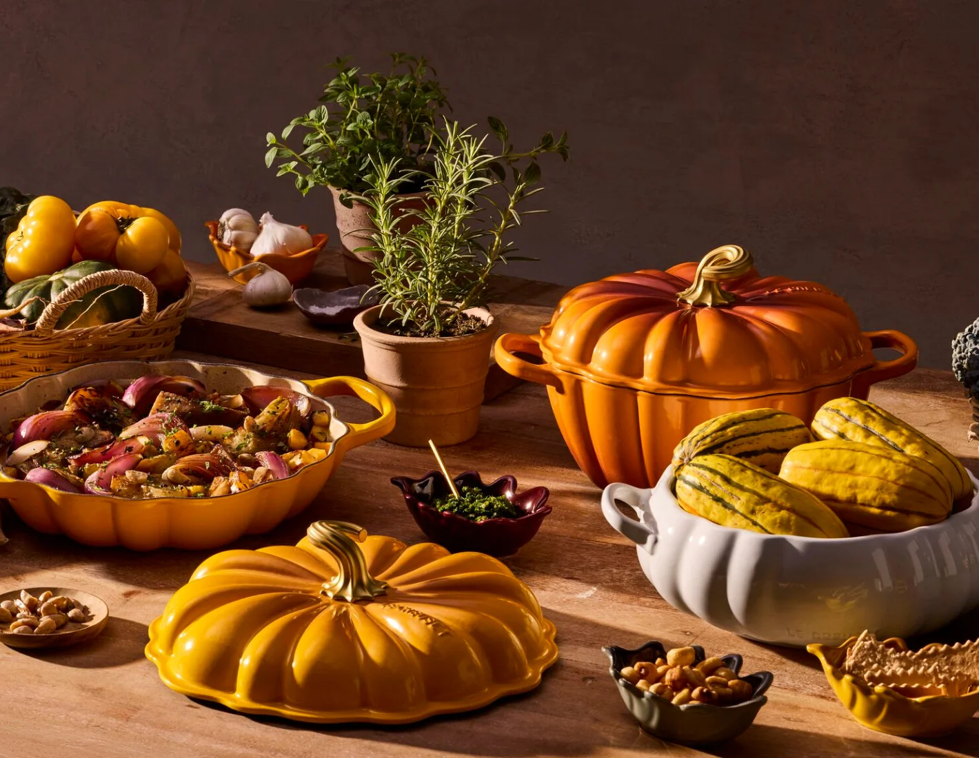 Le Creuset pumpkin-shaped cookware with a seasonal harvest table setting