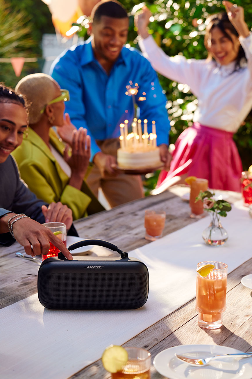 Group of People Listening to the Bose Bluetooth Portable Speaker Outdoors