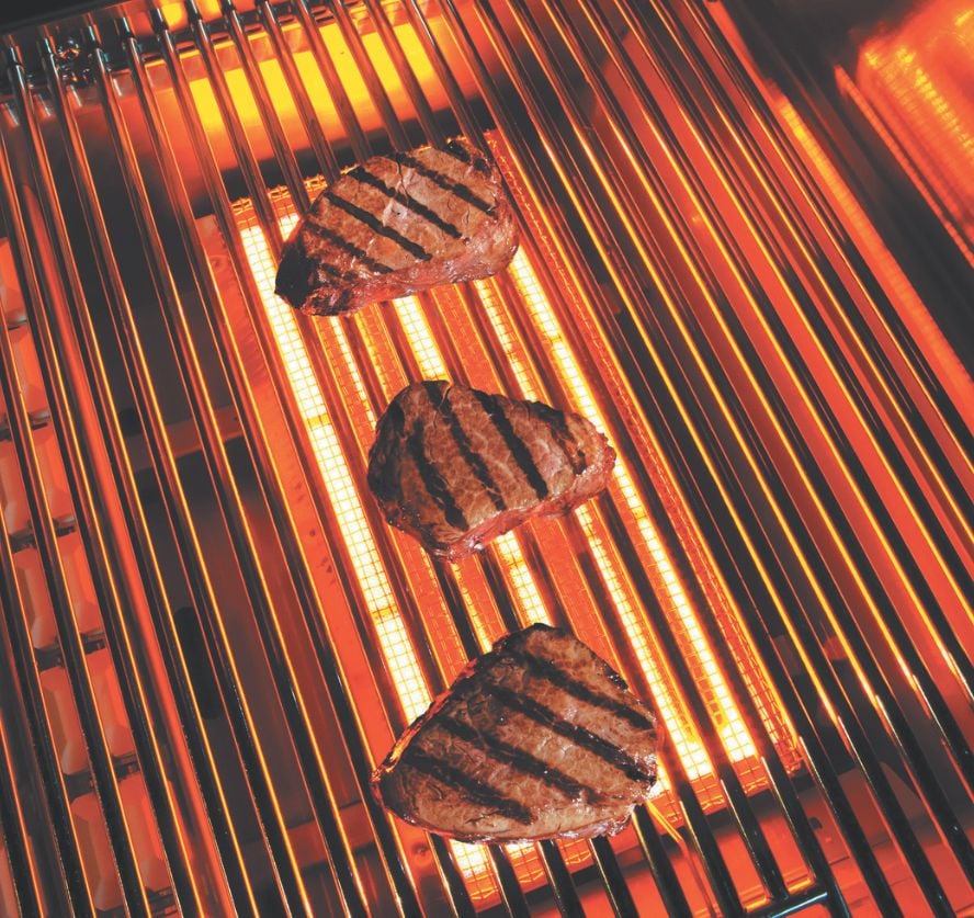 Close-up close up of the pro sear infrared burners on a lynx grill with filets griling on the burnersr
