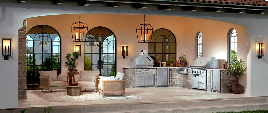 A luxury stone patio with cushioned chairs, a coffee table, an outdoor pizza oven, a grill and more