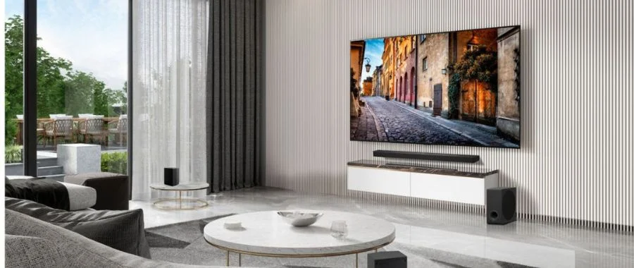 The LG S90TR Soundbar beneath a TV in a graymodern living room