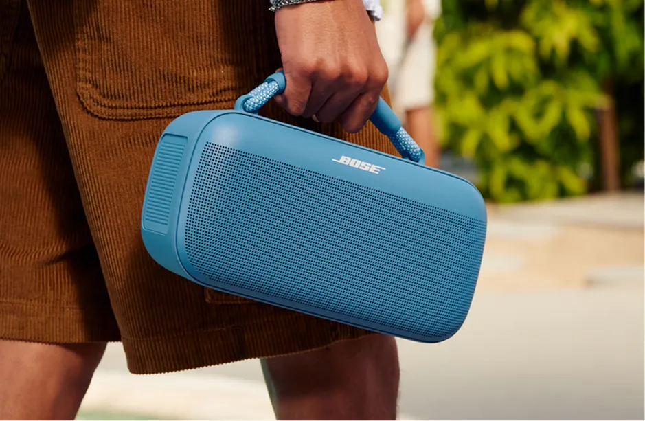 Portable speaker on a table at an outdoor gathering