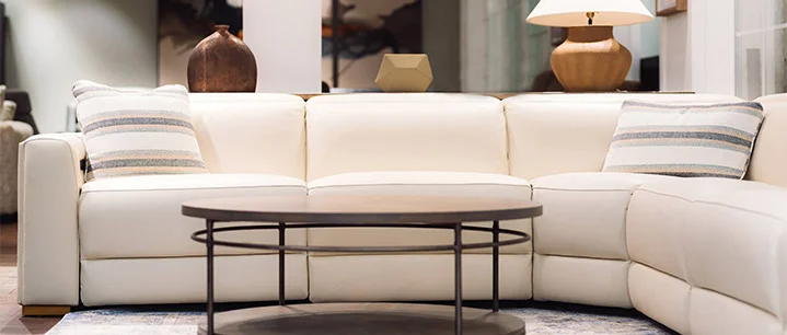 A stylish dining room featuring a glass table and elegant chairs, showcased in our furniture boutique showroom