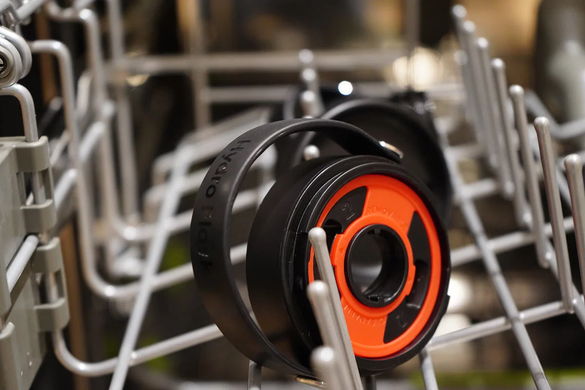 Close-up of a Hyrdo Flask Flex Sip Lid in the top rack of a dishwasher