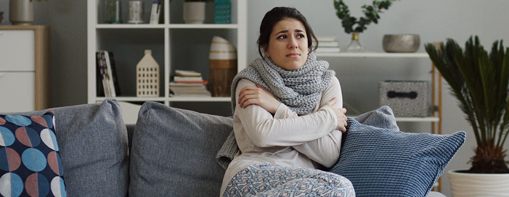 Person shivering on couch