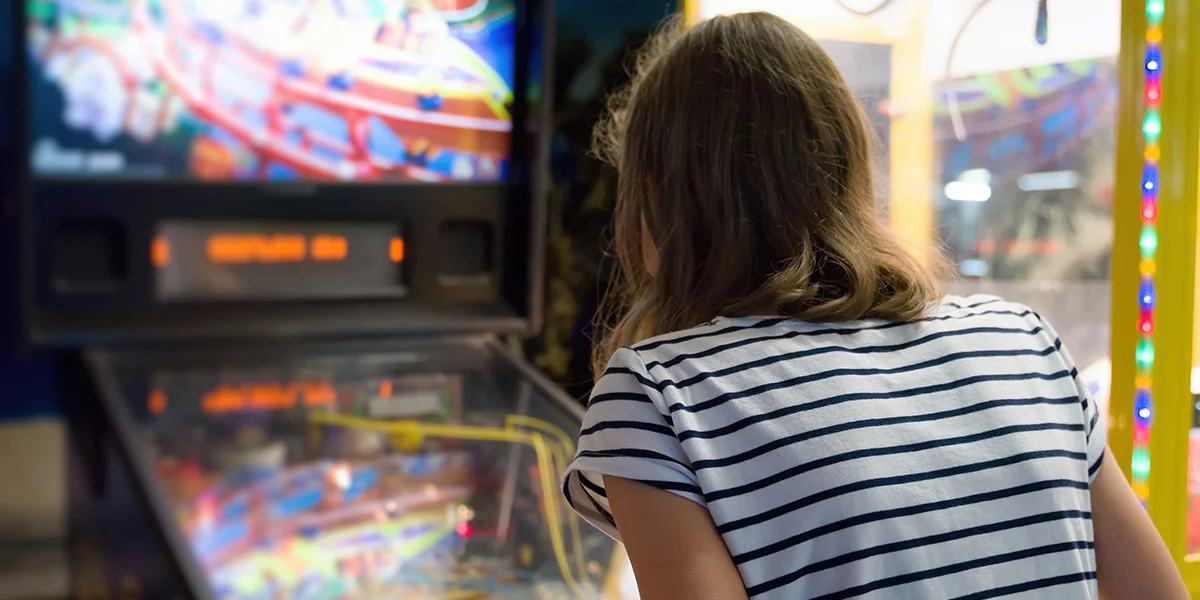 Adult and child playing pinball