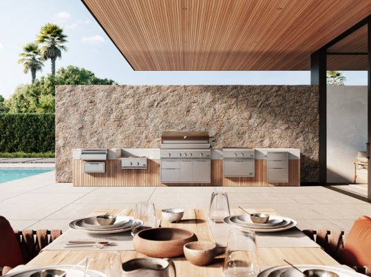 Sub-Zero built-in undercounter wine refrigerator with an open glass door showcasing beverages and wine inside