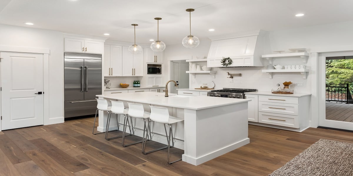 white kitchen with a stainless steel French door refrigerator