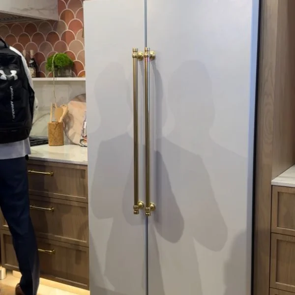 White Cafe side-by-side refrigerator with brass handles.