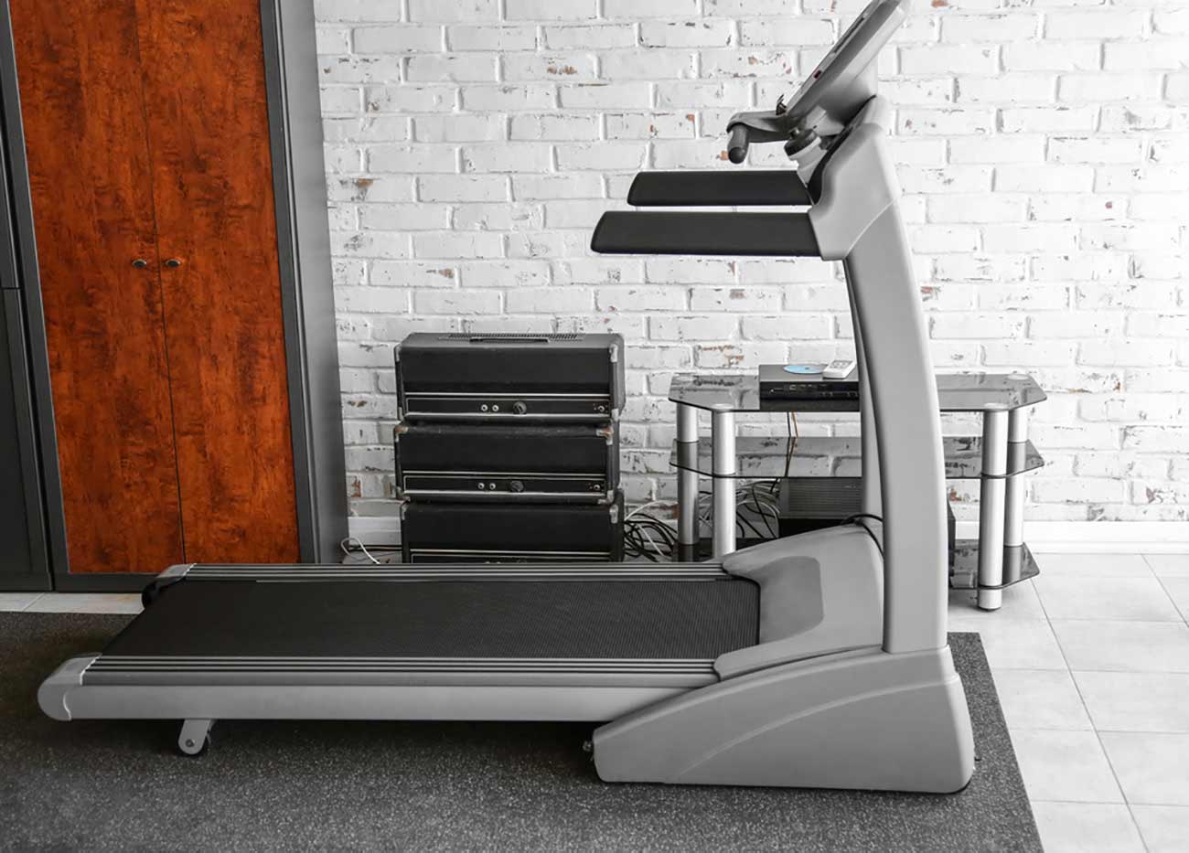Treadmill against brick wall