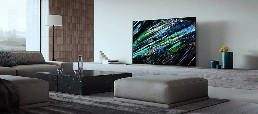 A TV sitting in a living room displaying an abstract painting