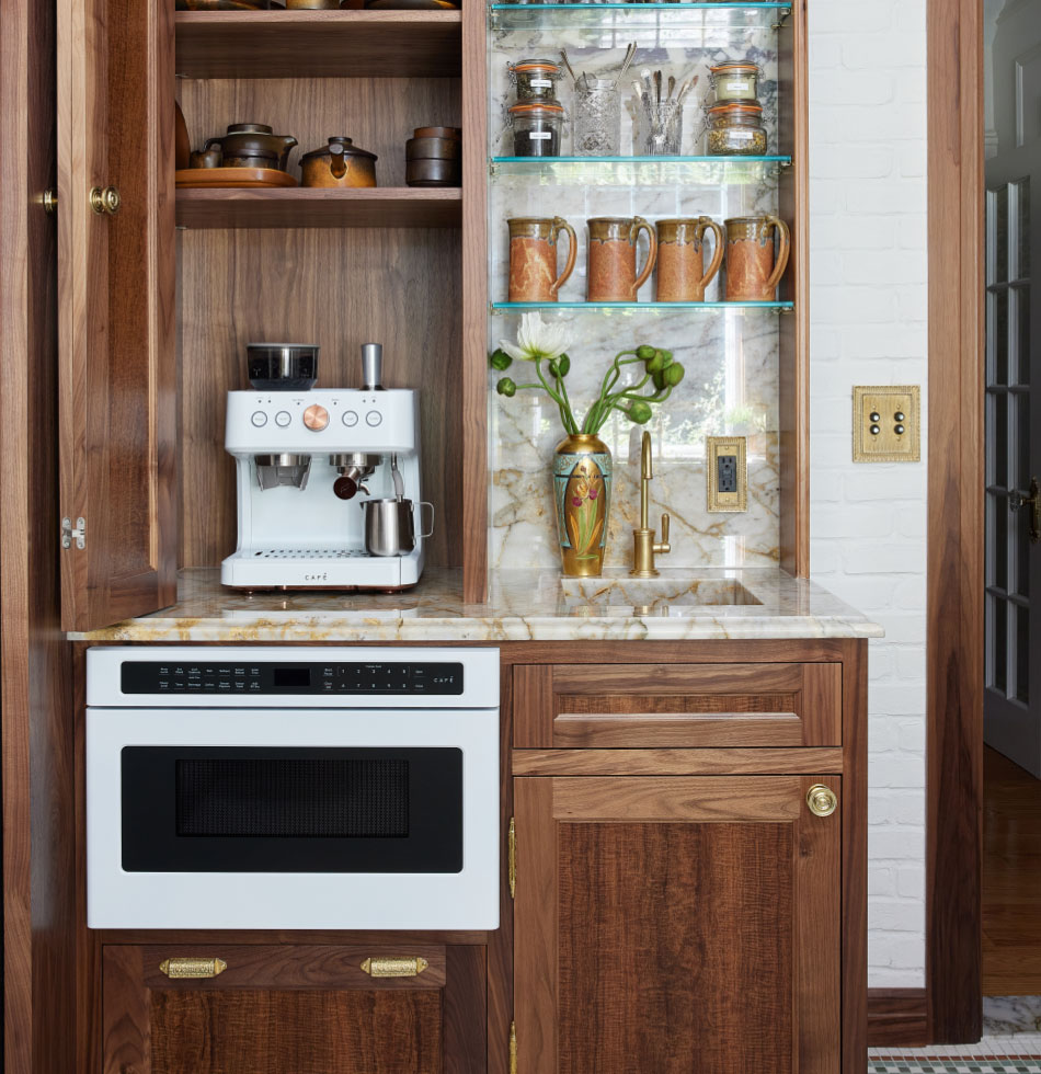 Elegant kitchen with wooden cabinetry, marble countertops, a built-in microwave drawer, and an espresso machine