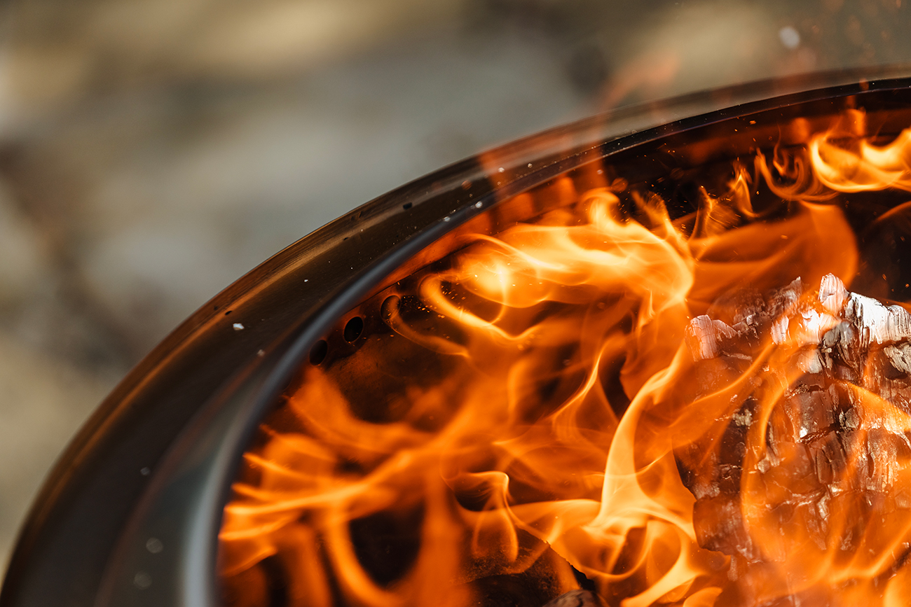 Lifestyle View of Solo Stove Canyon With Wood On Fire 3