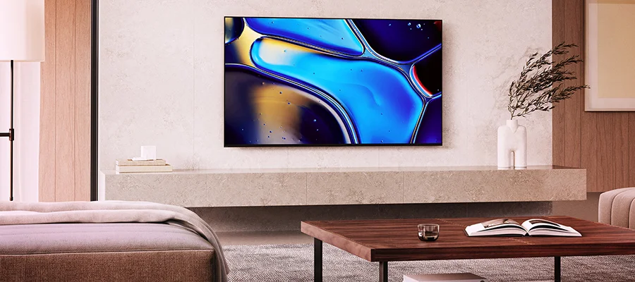 A flat screen TV mounted to a wall in a beige living room, display an abstract blue painting.