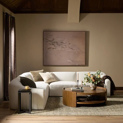 A stylish living room showcasing a white couch paired with a wooden table, emphasizing modern decor