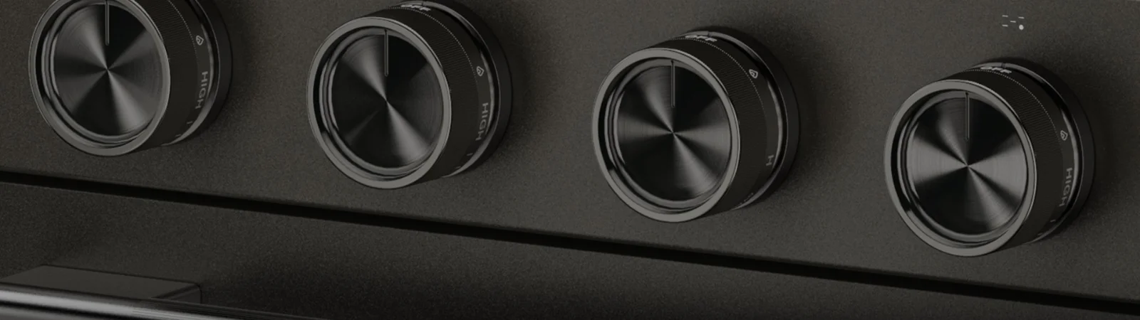 tight close up shot on the knobs of a black ore kitfhenaid range