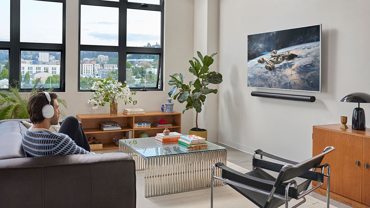 Man Listening to SONOS Soundbar in Living Room