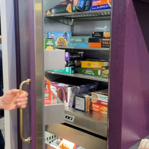 Person opening the door of a BlueStar built-in refrigerator in Purple Violet.