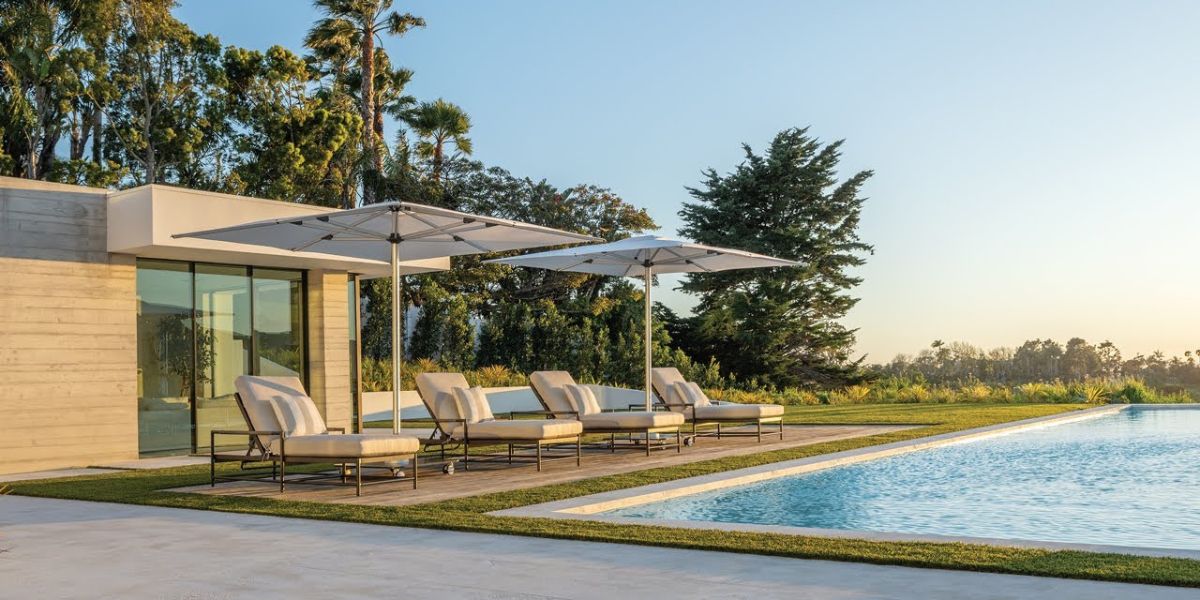 Two square-canopied umbrellas above seats beside a pool