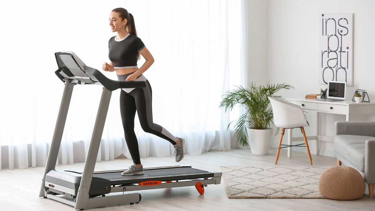 Woman with brown hair running on a treadmill