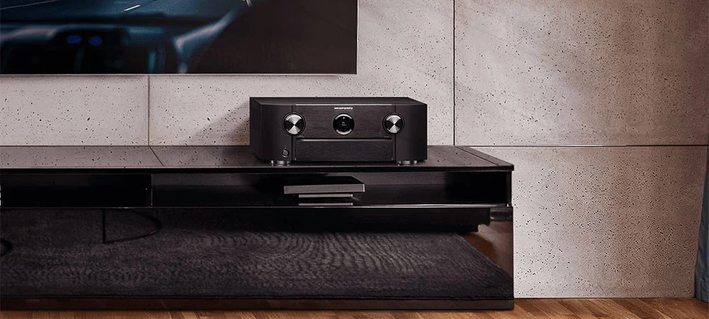 An Audio Receiver on a black TV stand
