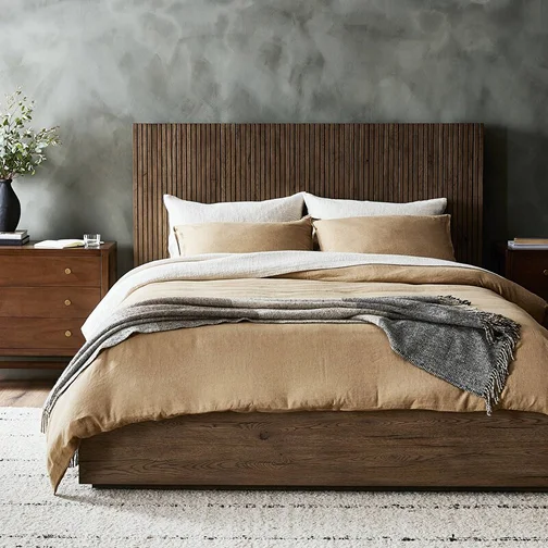 A wooden headboard bed paired with a wooden nightstand