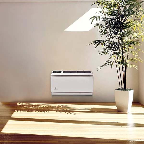 A wall air conditioner mounted in a white living room