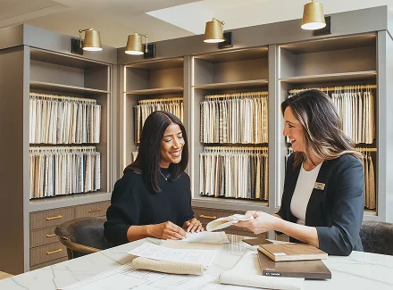 A designer sketching furniture layout plans at a desk
