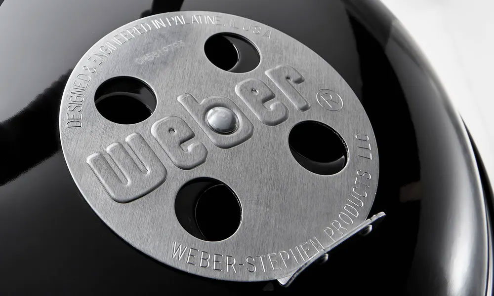 Close Up of Open Air Dampers on a Weber Charcoal Smoker and Grill
