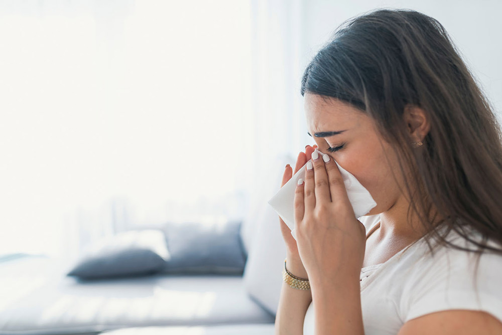 Person with tissue by their nose
