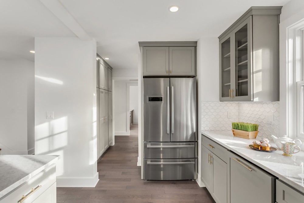 Stainless steal counter depth refrigerator in a kitchen