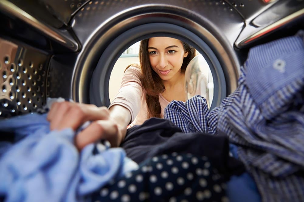 Person pulling clothes out of a dryer