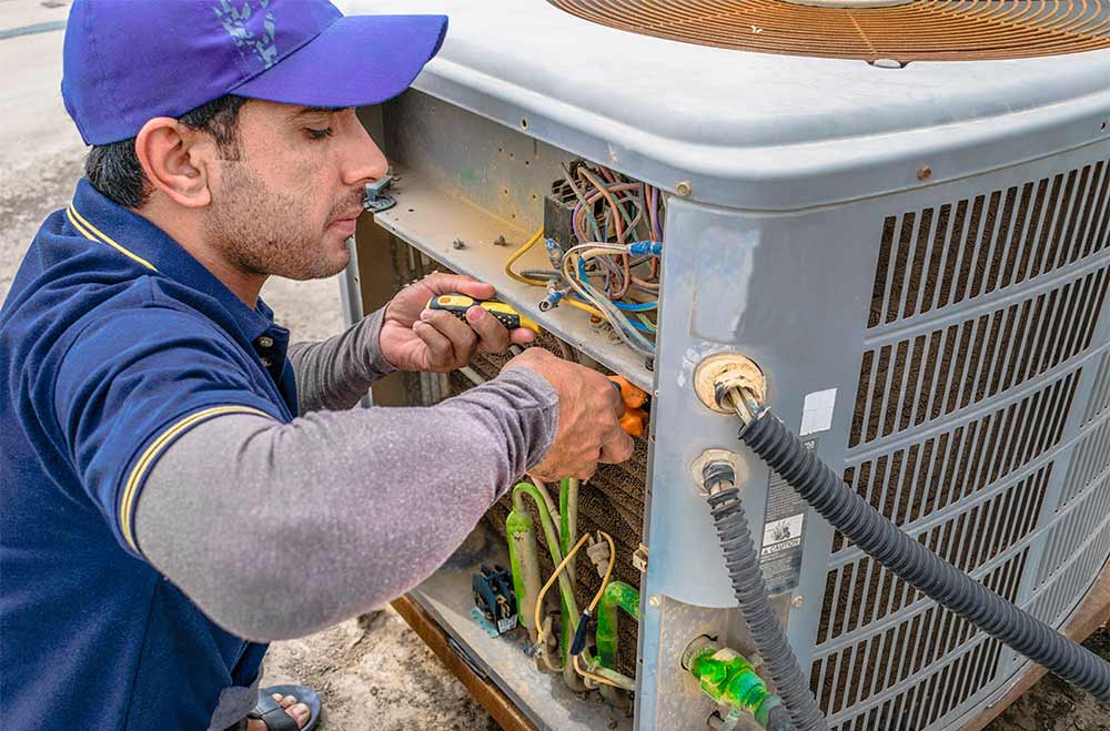 Repair-person fixing air conditionerz