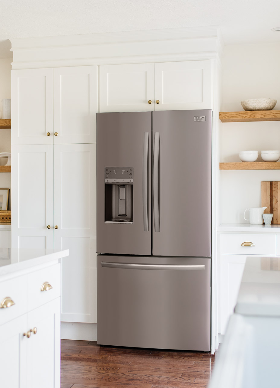 A nice white kitchen highlighting the frigidaire gallery stainless steel refrigerator with external water dispenser