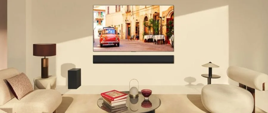 An LG TV and soundbar mounted on the wall in a living room
