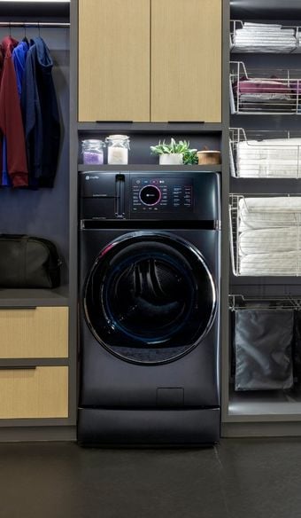 Tight shot of a ge profile all in one laundry washer and dryer put into a closet setting