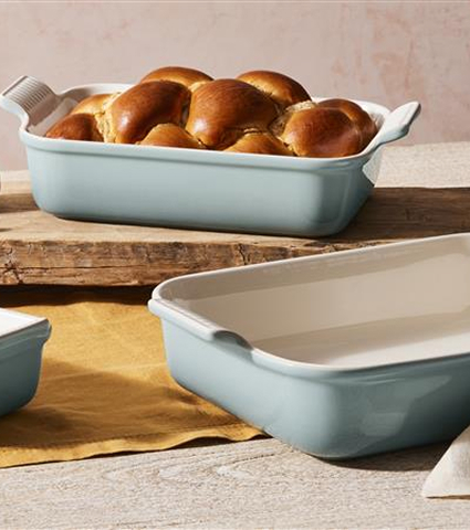 One Empty Dish and One Holidng Freshly Baked Bread