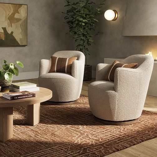 A living room scene with two comfortable chairs and a central coffee table, inviting relaxation and conversation.