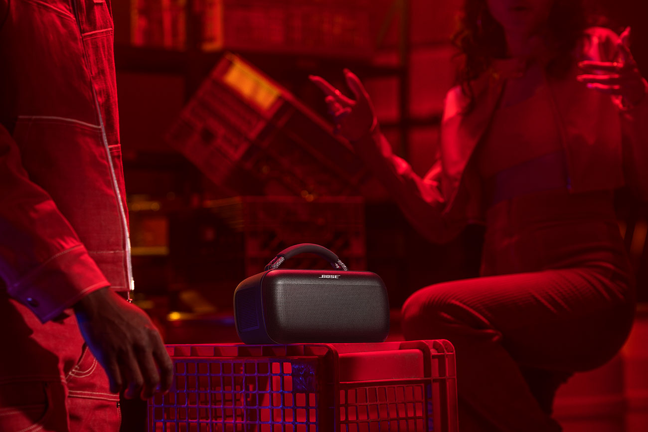 Group of People Listening to the Bose Bluetooth Portable Speaker Indoors