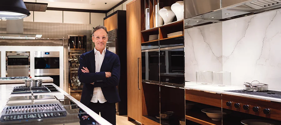 Mick De Giulio standing in the middle of one of the luxury kitchens featured in Abt's Inspiration Studio