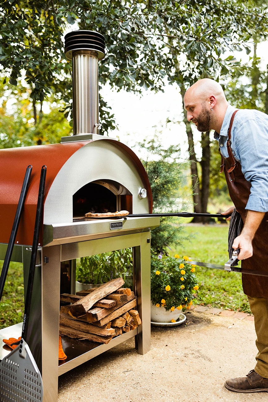 Feature View of Man Putting Pizza in Oven