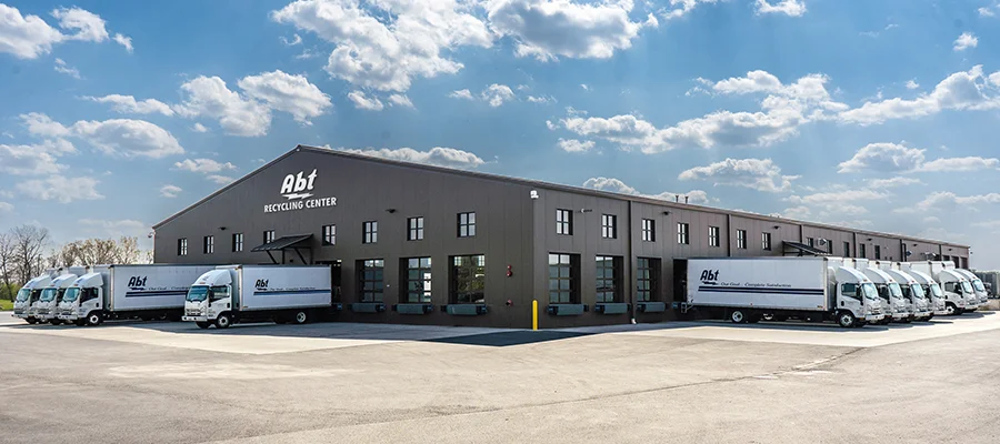 The Abt Recycling Center with multiple Abt trucks parked outside