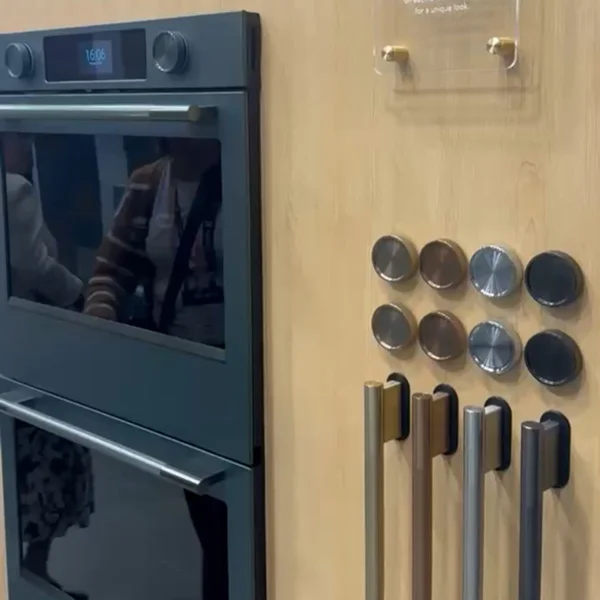 dark green oven alongside display of different colored hardware options