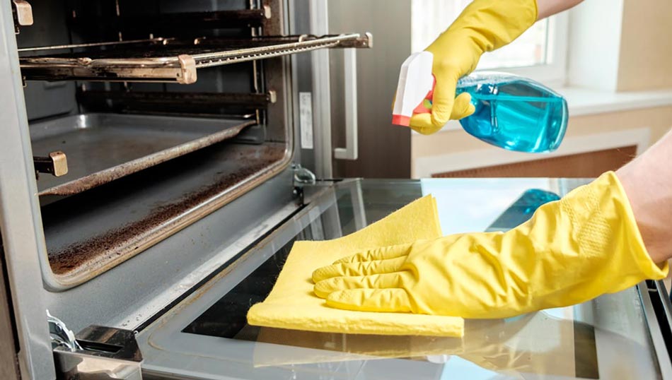 Using a spray bottle with cleaning solution to clean an oven