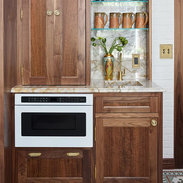 white microwave drawer installed in dark wood cabinets