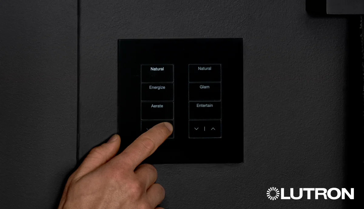 A hand using a Lutron wall control